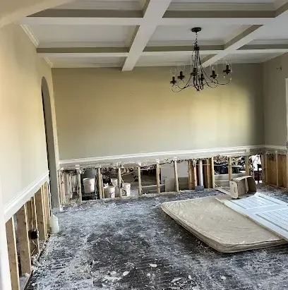 A dining room with the drywall flood cut and the flooring stripped during drying