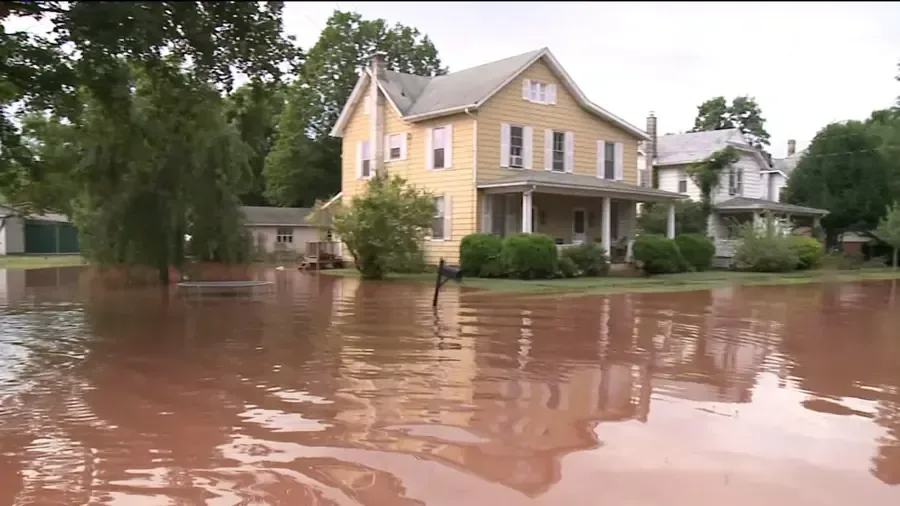 Floodwater spread across the yards of two-story homes after heavy rain
